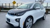 Front view of a sleek BMW i3 electric vehicle parked outdoors,