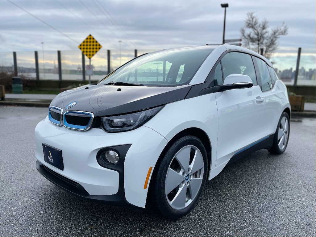 Front view of a sleek BMW i3 electric vehicle parked outdoors,
