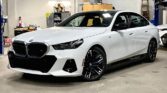 A BMW i5 electric parked outdoors, showcasing its sleek design and modern features, emphasizing luxury and sustainability.