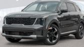 "Front view of a black Kia SUV with modern LED headlights and a bold black grille, parked outdoors."