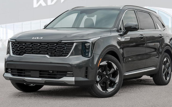 "Front view of a black Kia SUV with modern LED headlights and a bold black grille, parked outdoors."